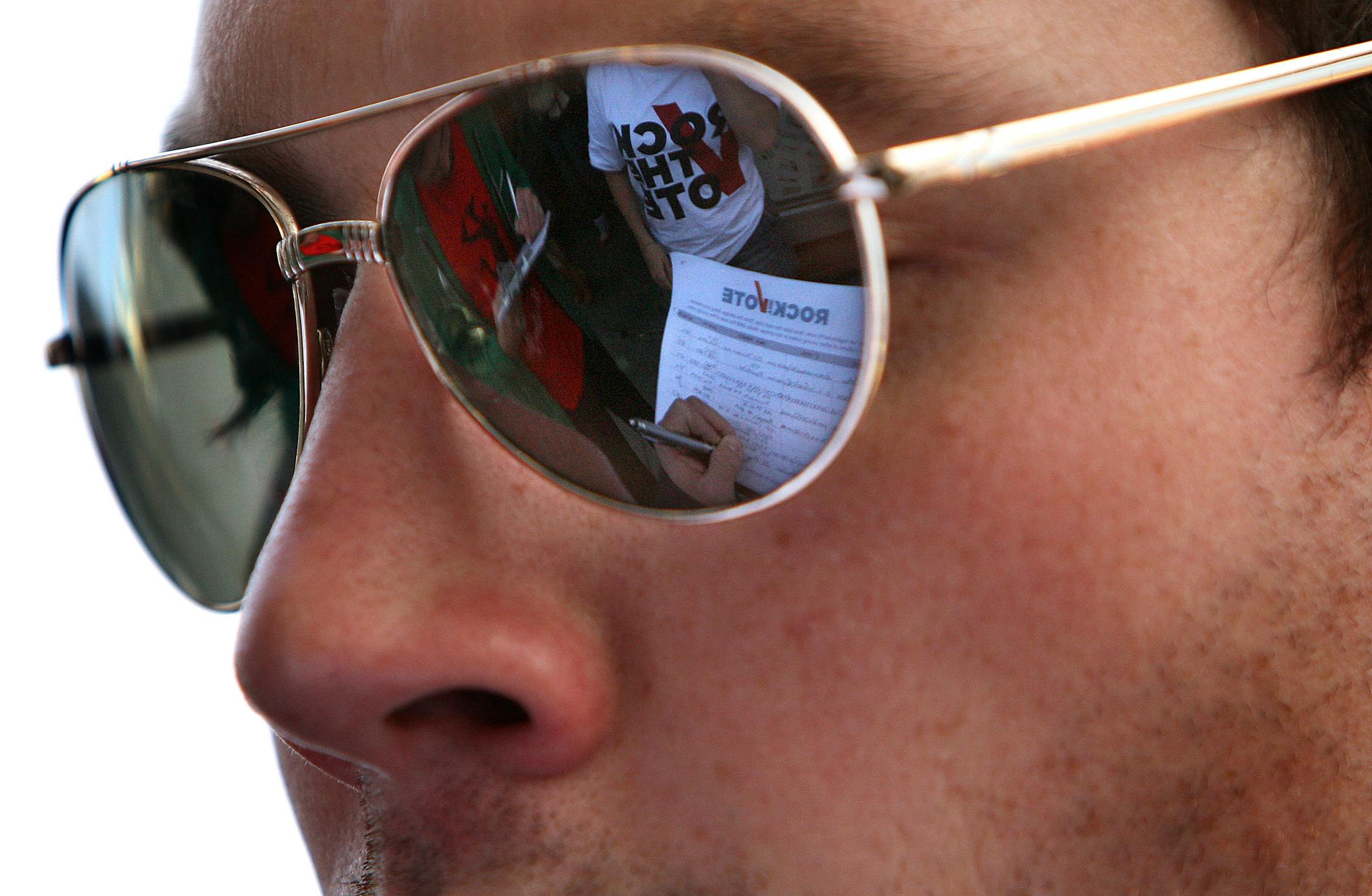 Chuck Dusbabeck, 29, of St. Paul registered to vote outside the Electric Fetus music store in Minneapolis on Monday; reflected in his glasses is a voter registration form, part of the Rock the Vote effort that had come to the area to sign up new voters.