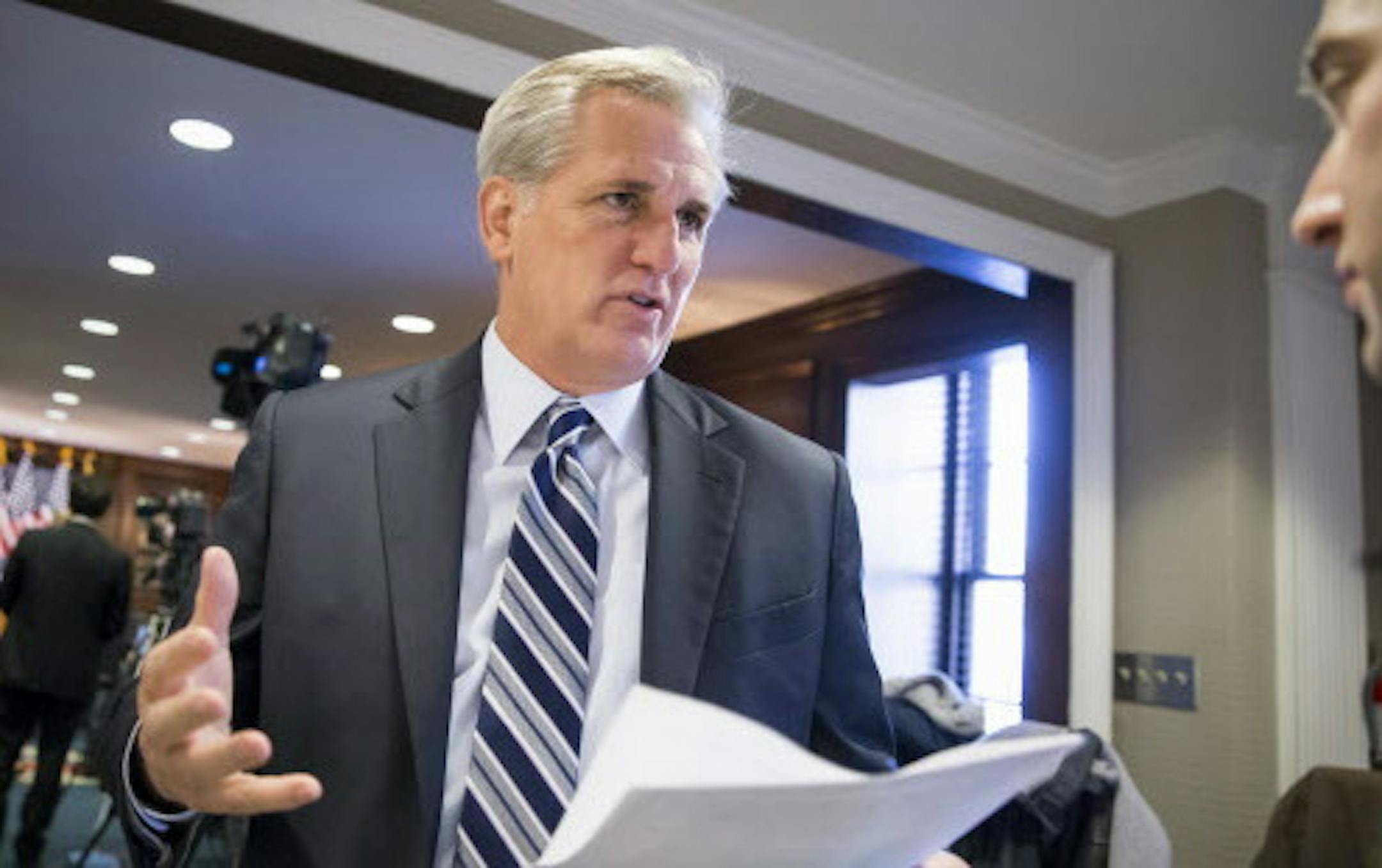 Majority Leader Kevin McCarthy, R-Calif., speaks with a reporter following a closed-door GOP caucus meeting at the Republican National Headquarters on Capitol Hill in Washington, Tuesday, Dec. 8, 2015. Invoking the Paris terror attacks, House lawmakers pushed toward a vote Tuesday on legislation tightening controls on travel to the U.S. and requiring visas for anyone who's been in Iraq or Syria in the previous five years. "You have more than 5,000 individuals that have Western passports in this