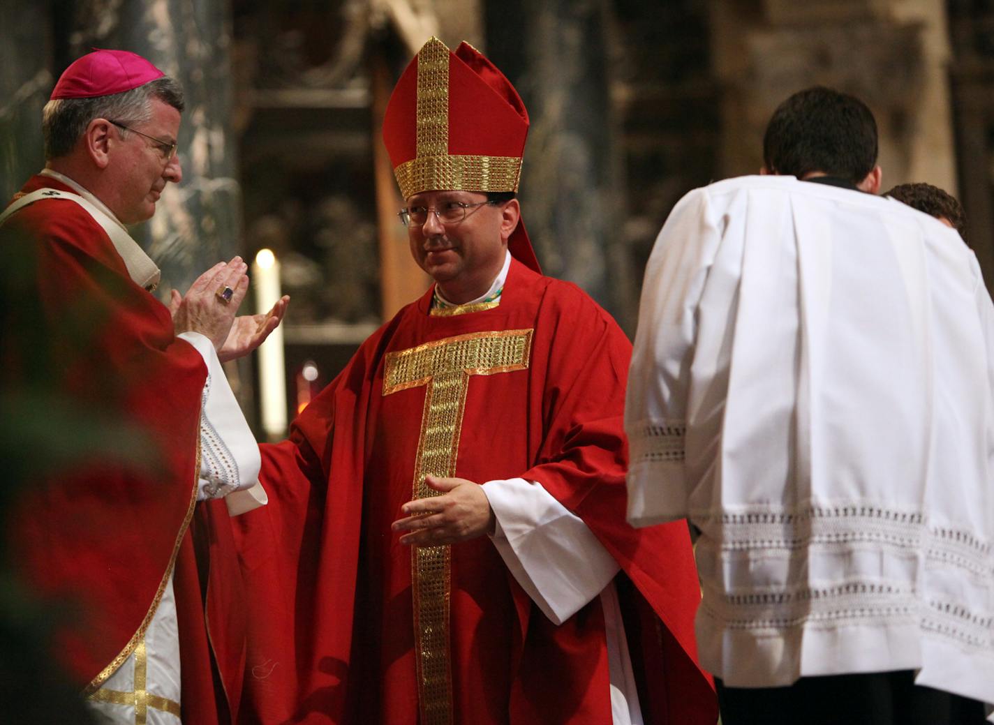 RENEE JONES SCHNEIDER &#xef; reneejones@startribune.com St. Paul, Minn. 6/29/09 ] Archibishop John C. Nienstedt applauded newly ordained Auxiliary Bishop Lee Anthony Pich&#xc8; Monday at the Cathedral of St. Paul Monday.