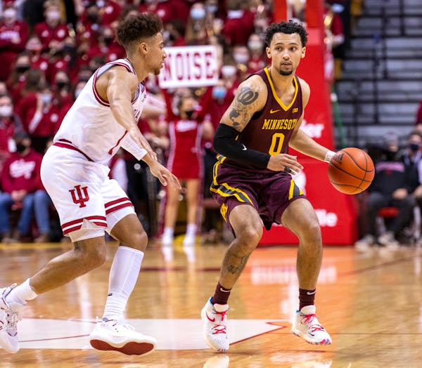 Minnesota guard Payton Willis (0) works the ball around the defense of Indiana guard Rob Phinisee (1) during the first half Sunday.
