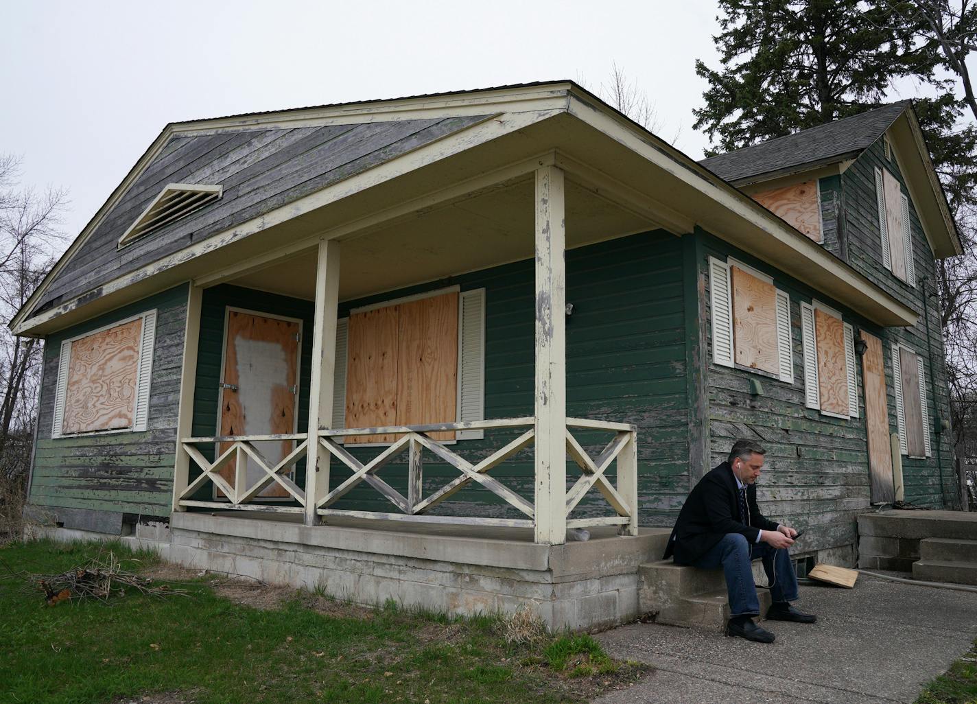 Dan Gustafson with the Heritage Preservation Board worked from his phone outside the 1902 Section Foreman's House, a possible candidate for the National Register of Historic Places where the railroad foreman used to live, Thursday in Wayzata. ] ANTHONY SOUFFLE &#x2022; anthony.souffle@startribune.com The 1902 Section Foreman's House, a possible candidate for the National Register of Historic Places where the railroad foreman used to live, sat rundown and boarded up Thursday, April 25, 2019 in Wa