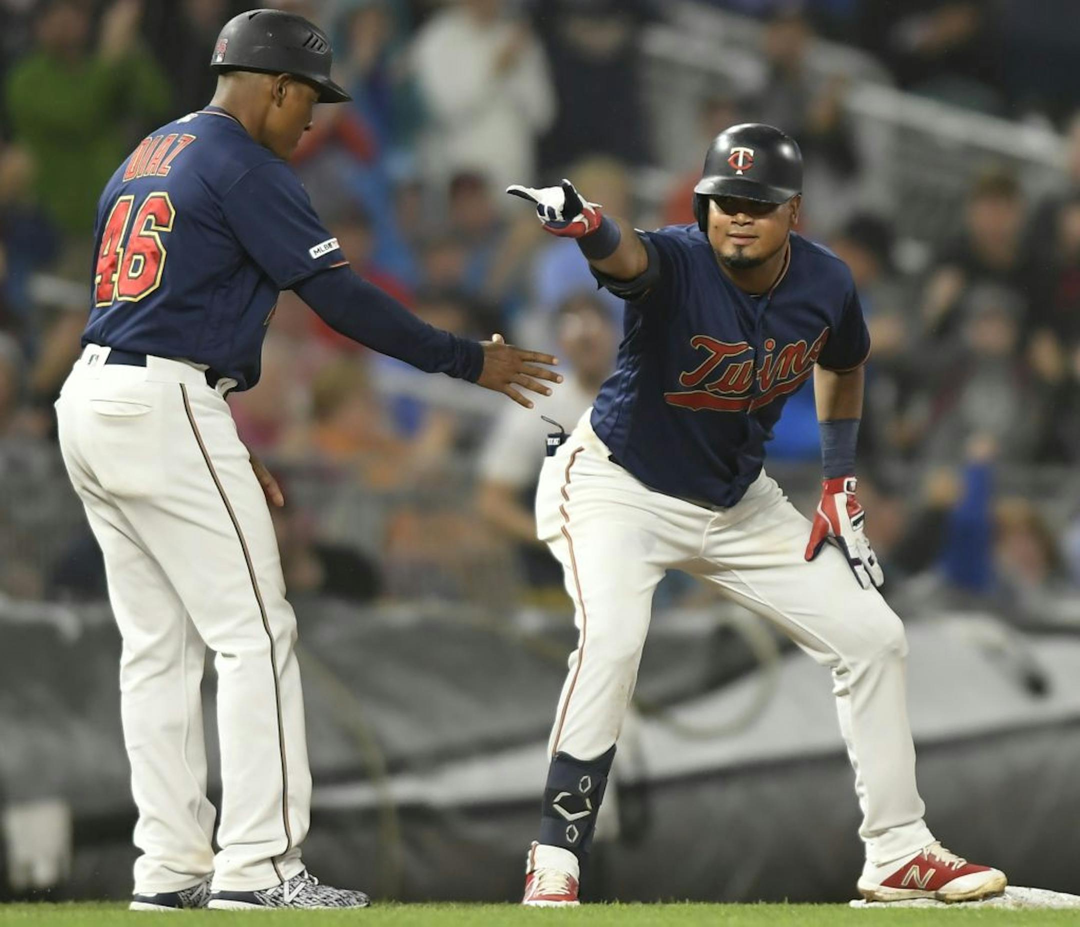 Minnesota Twins second baseman Luis Arraez (2) celebrated with third base coach Tony Diaz (46) after Arraez tripled in the bottom of the fourth inning off a pitch by Cleveland Indians starting pitcher Adam Plutko (45).