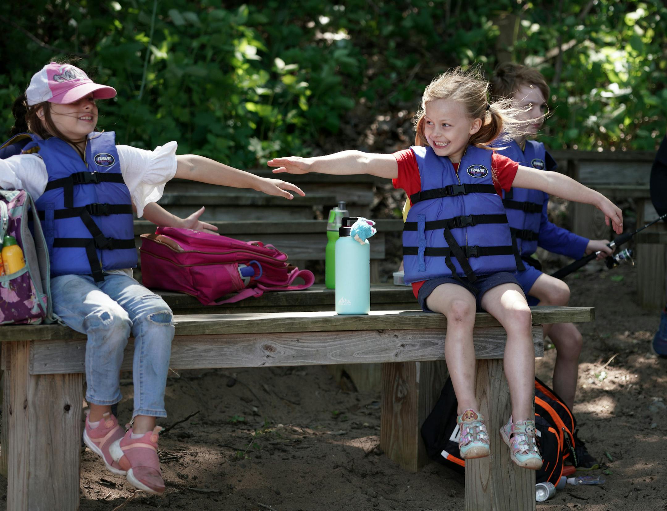 Campers and counselors at YMCA Camp Day Croix during their first week. This is one of the camps that is ON this summer, while others, including YMCA overnight camps, are canceled. Here, Josephine, 7 and Finley, 6, measure their social distancing before going out for a canoe ride. brian.peterson@startribune.com Hudson, WI Thursday, June 11, 2020