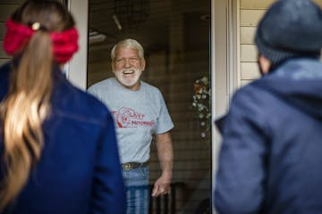 Tasha Huebl, left, and Alexandra Tup knock door to door in a neighborhood in Prior Lake for the Trump ticket. Terry Anderson was happy to chat briefly