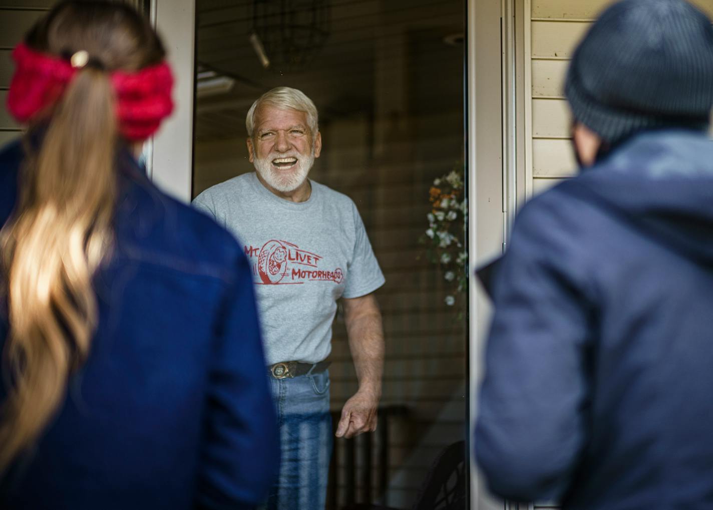 Tasha Huebl, left, and Alexandra Tup knock door to door in a neighborhood in Prior Lake for the Trump ticket. Terry Anderson was happy to chat briefly.