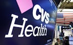The CVS Health logo appears above a trading post on the floor of the New York Stock Exchange, Monday, Dec. 4, 2017. Drugstore operator CVS is making a