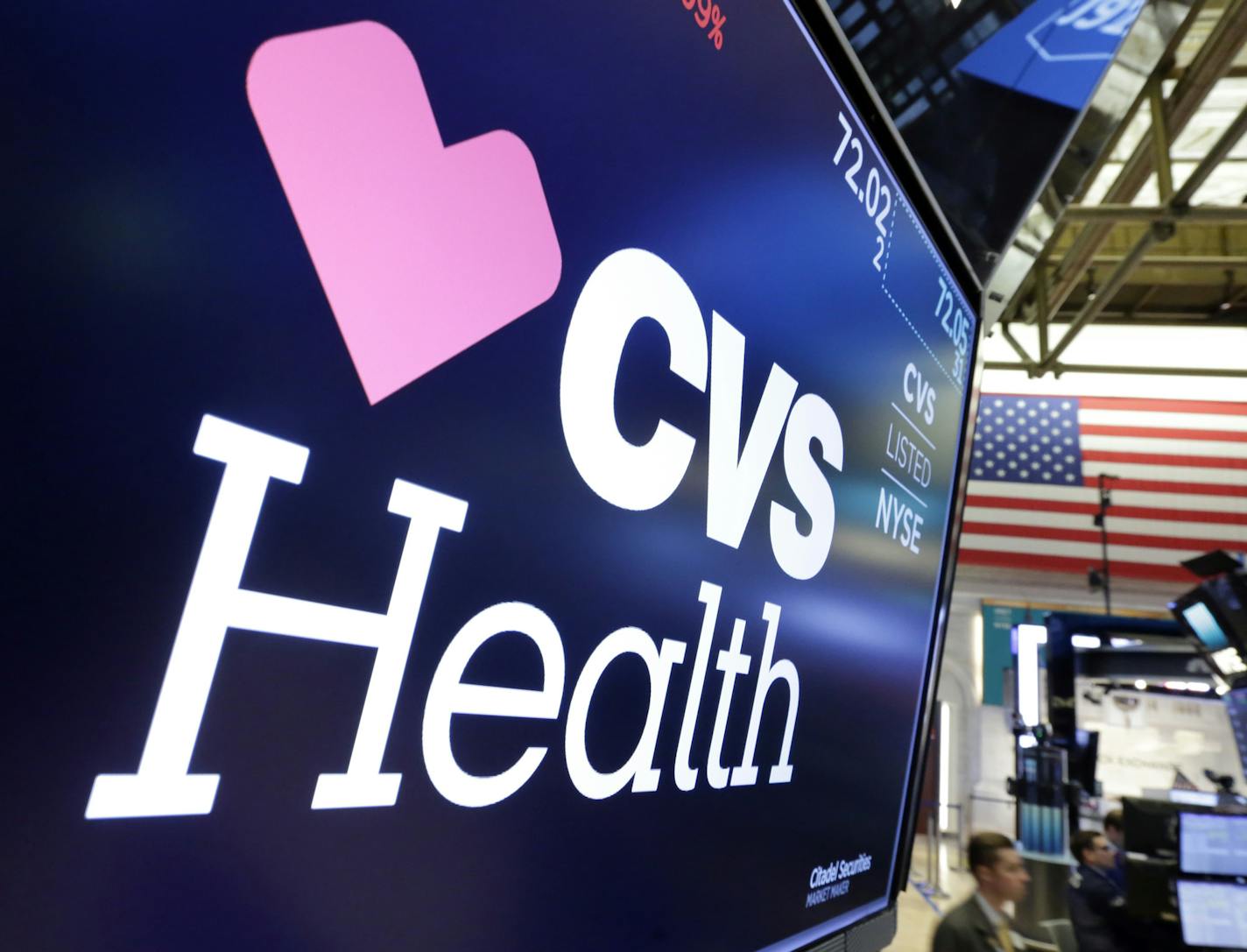 The CVS Health logo appears above a trading post on the floor of the New York Stock Exchange, Monday, Dec. 4, 2017. Drugstore operator CVS is making a $69 billion offer for insurer Aetna as it tries to position itself as a one-stop shop for Americans' health care needs with prescription drugs, clinics and insurance plans to cover those goods and services. (AP Photo/Richard Drew)