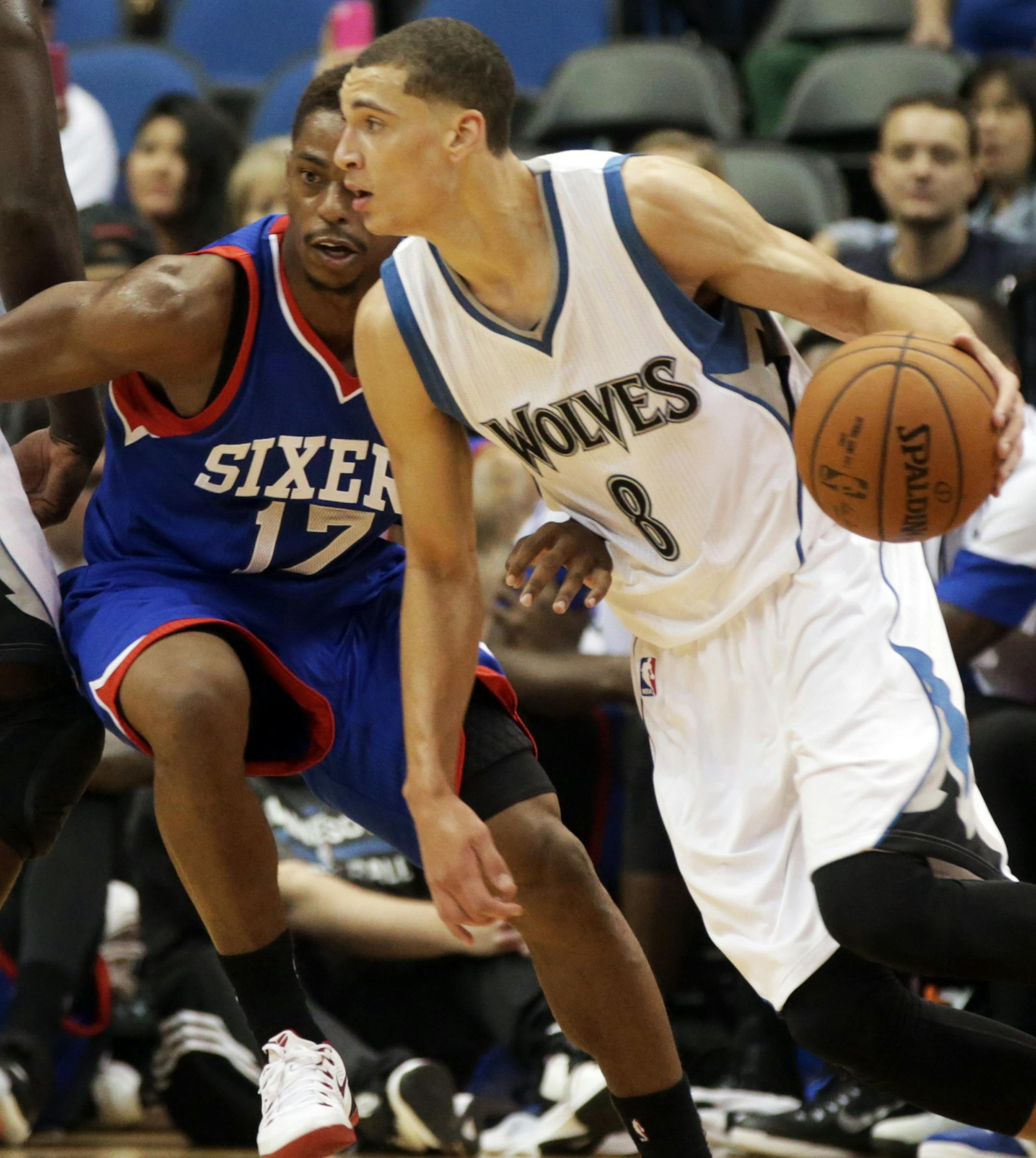 Minnesota Timberwolves rookie Zach LaVine, right, drives around Philadelphia 76ers' Casper Ware in the second of an NBA preseason basketball game, Friday, Oct. 10, 2014, in Minneapolis. The Timberwolves won 116-110. (AP Photo/Jim Mone) ORG XMIT: MNJM10