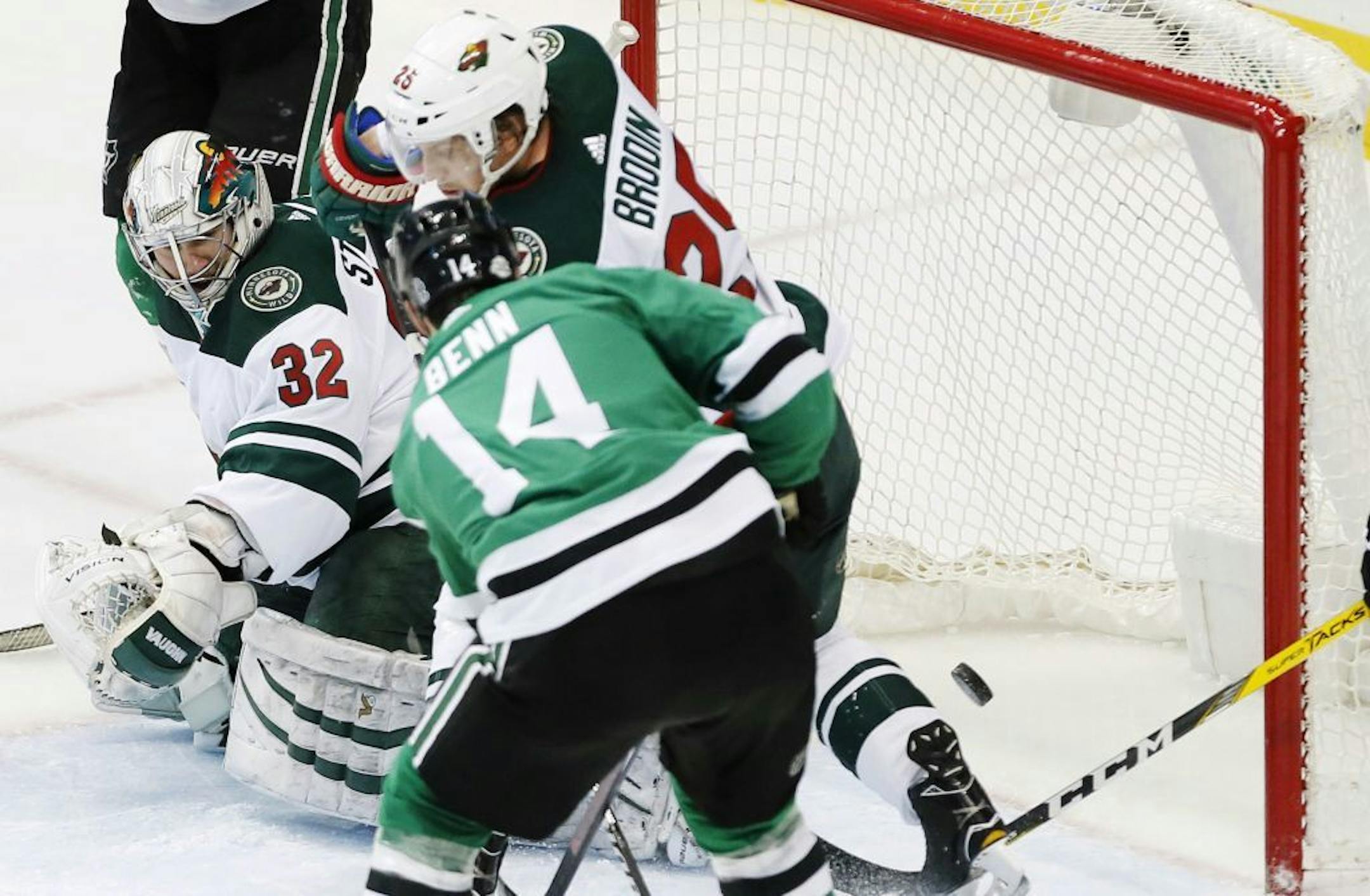 Dallas Stars forward Jamie Benn (14) shoots a rebound past Minnesota Wild defenseman Jonas Brodin (25) and goaltender Alex Stalock (32) during the second period of an NHL hockey game Saturday, Feb. 3, 2018, in Dallas.