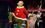 Reed Sigmund as the Grinch and Natalie Tran as young Max in the Children's Theatre Company's "How the Grinch Stole Christmas."