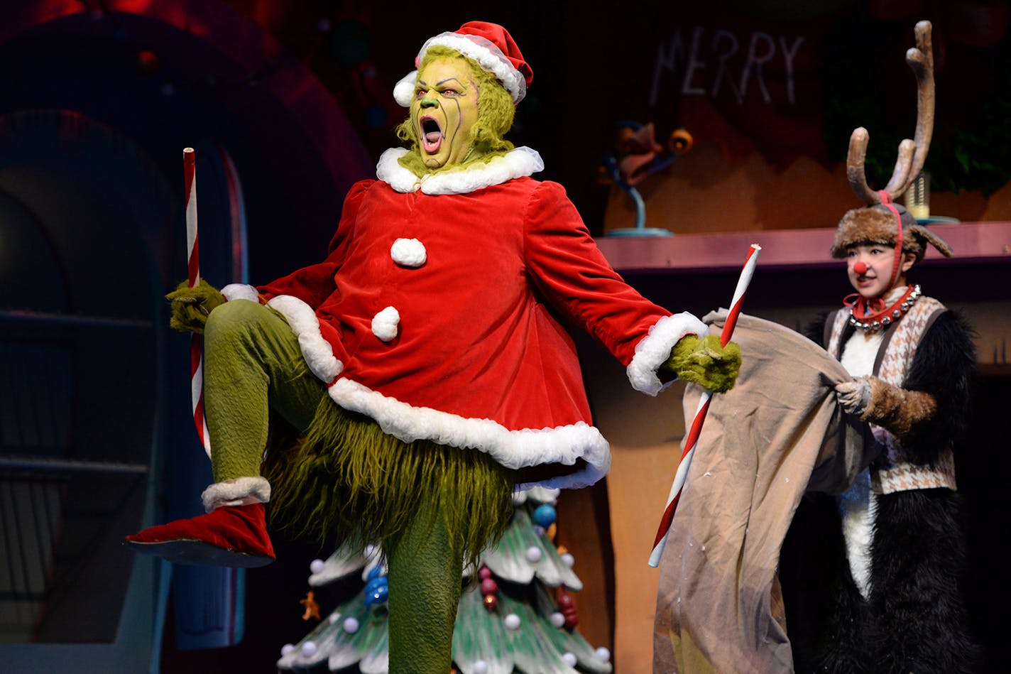 Reed Sigmund as the Grinch and Natalie Tran as young Max in the Children's Theatre Company's "How the Grinch Stole Christmas."