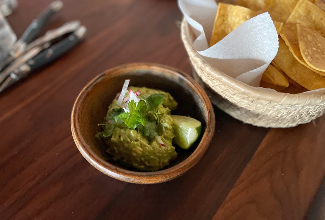 Guacamole and chips are just one of the familiar appetizers available to snack on while enjoying a beverage and perusing the menu at Chilango.