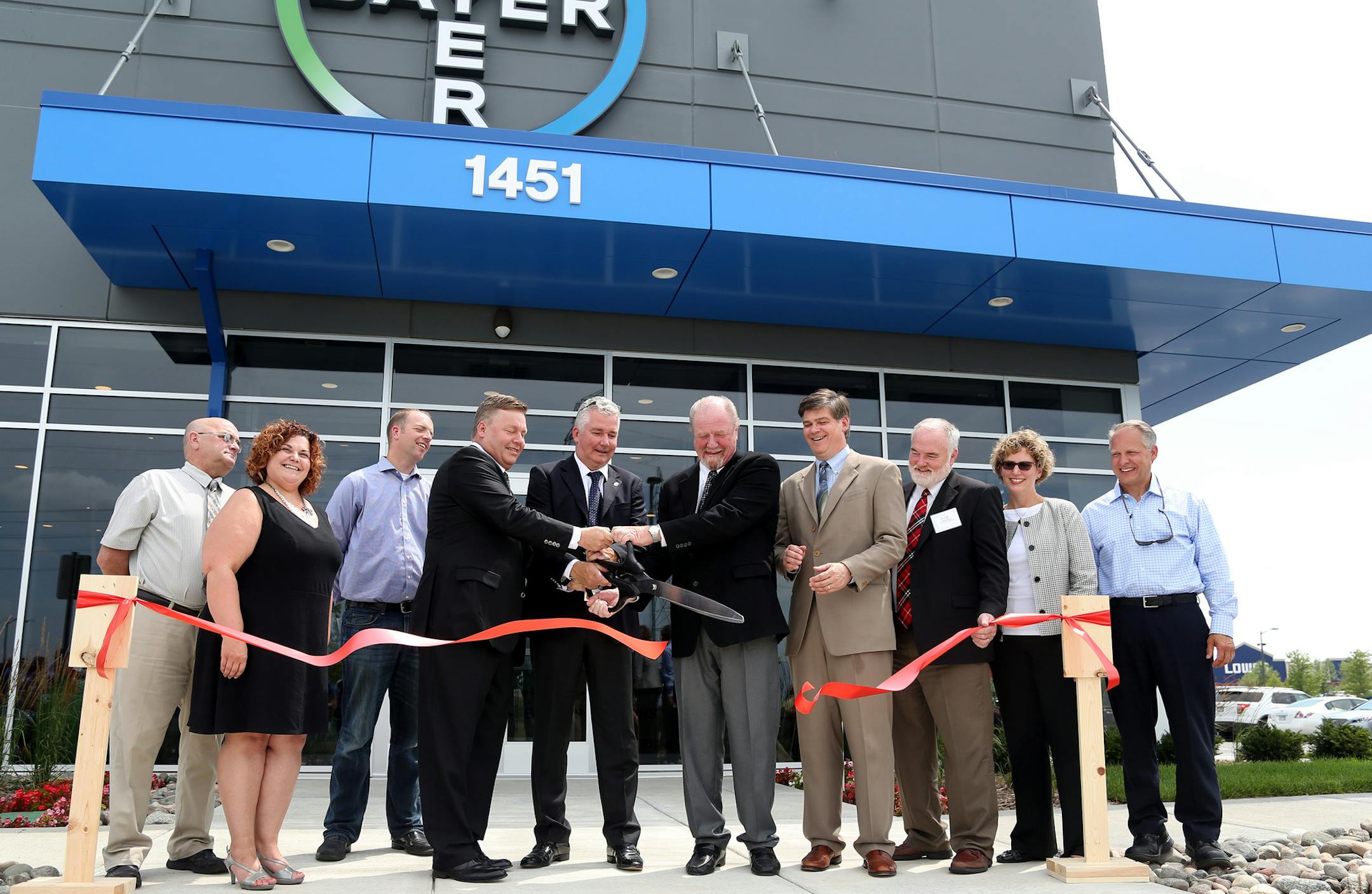 In the middle, Jim Blome, Matthais Haug and Mark Belden, held the scissors to cut the ribbon during the dedication of the new Bayer CropScience facility. ] (KYNDELL HARKNESS/STAR TRIBUNE) kyndell.harkness@startribune.com Dedication of a new $12 million seed innovation center in Shakopee. Bayer CropScience to hold the grand opening and tour of new facilityin Shakopee, Min., Thursday, July 9, 2015.