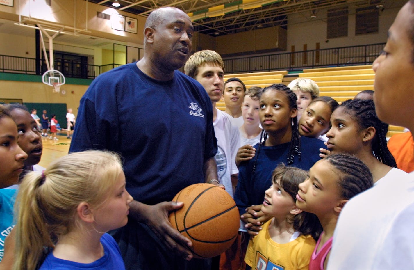 IN THIS PHOTO: Brooklyn Park, MN., Thursday, 6/28/2001. Former Gophers basketball player, Clyde Turner pulled a group of kids attending his basketball camp together to talk after a break for lunch. The week long camp was being held at the Park Center High School. Feature on Clyde Turner, a former Gophers basketball player who is running a youth basketball camp for the 20th consecutive year. Story will focus on how Turner has given back to the community following his days as a player.