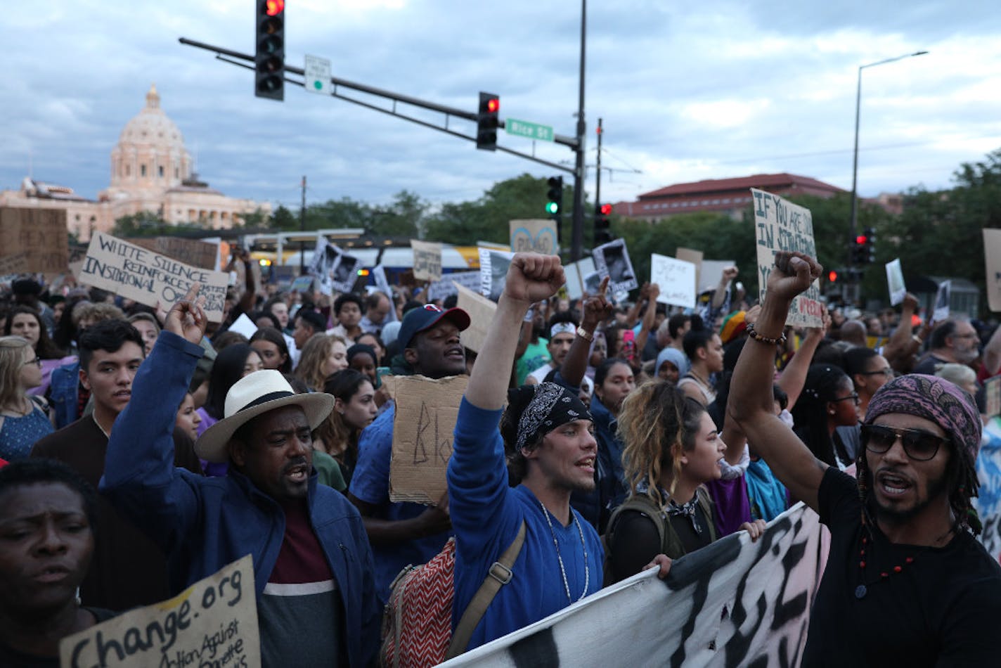 Supporters of Philando Castile held signs as they marched along University Avenue in St. Paul on Friday night after a vigil and rally at the State Capitol.