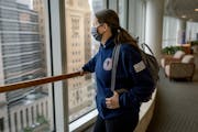 Amanda Barbosa stops in the chemotherapy wing at Mayo hospital to take a breather and look outside as she waits for her husband Rafael, in Rochester, 