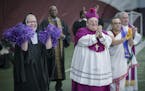 Local religious leaders, including Archbishop Bernard Hebda, center, cheered on those that were throwing a football for the filming of a commercial fe