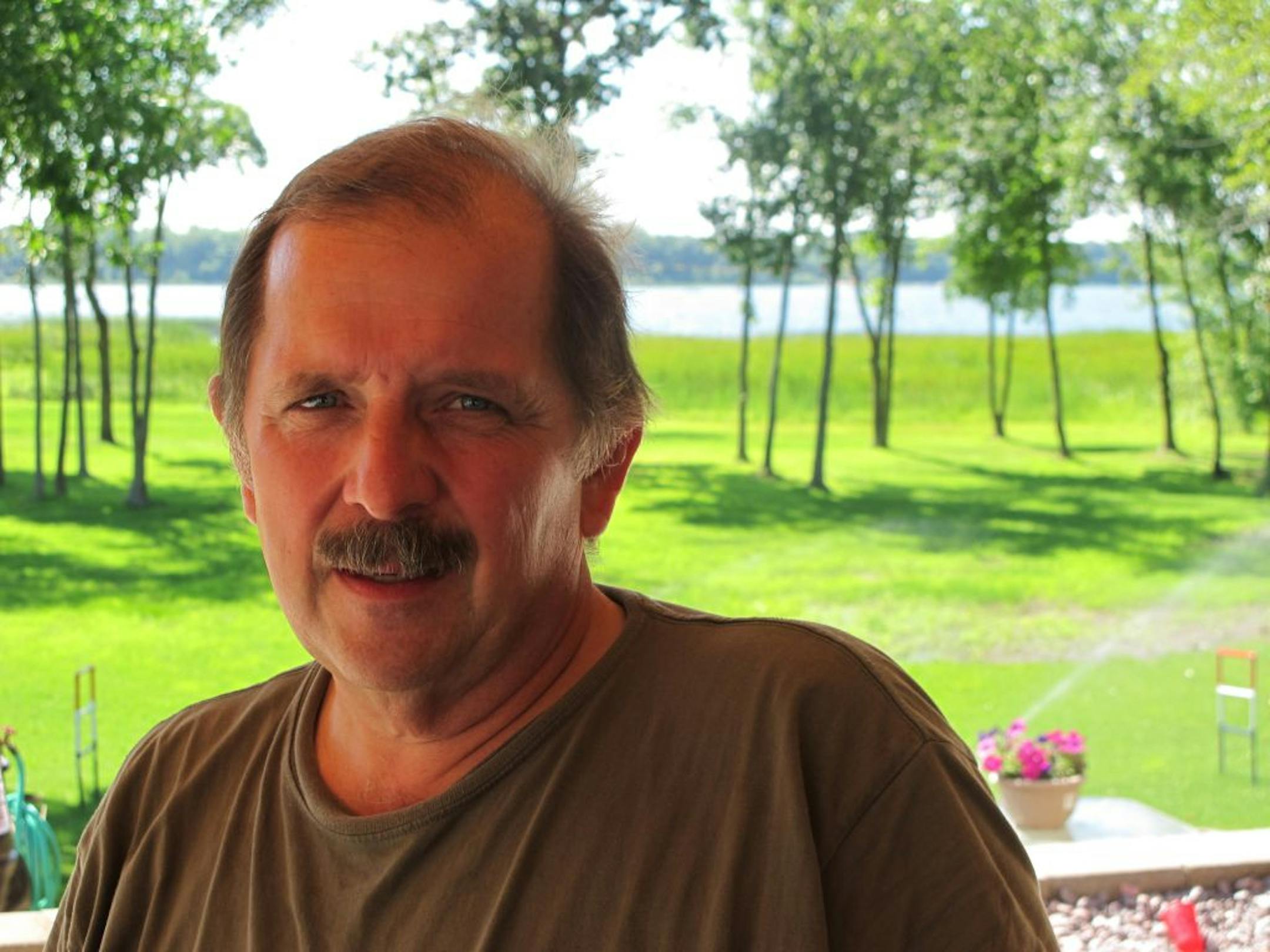 Photo by Kevin GilesBrent Reibel built his house on 17 acres he bought along Big Marine Lake in northern Washington County. The easement in question lies in the grassy area behind him.