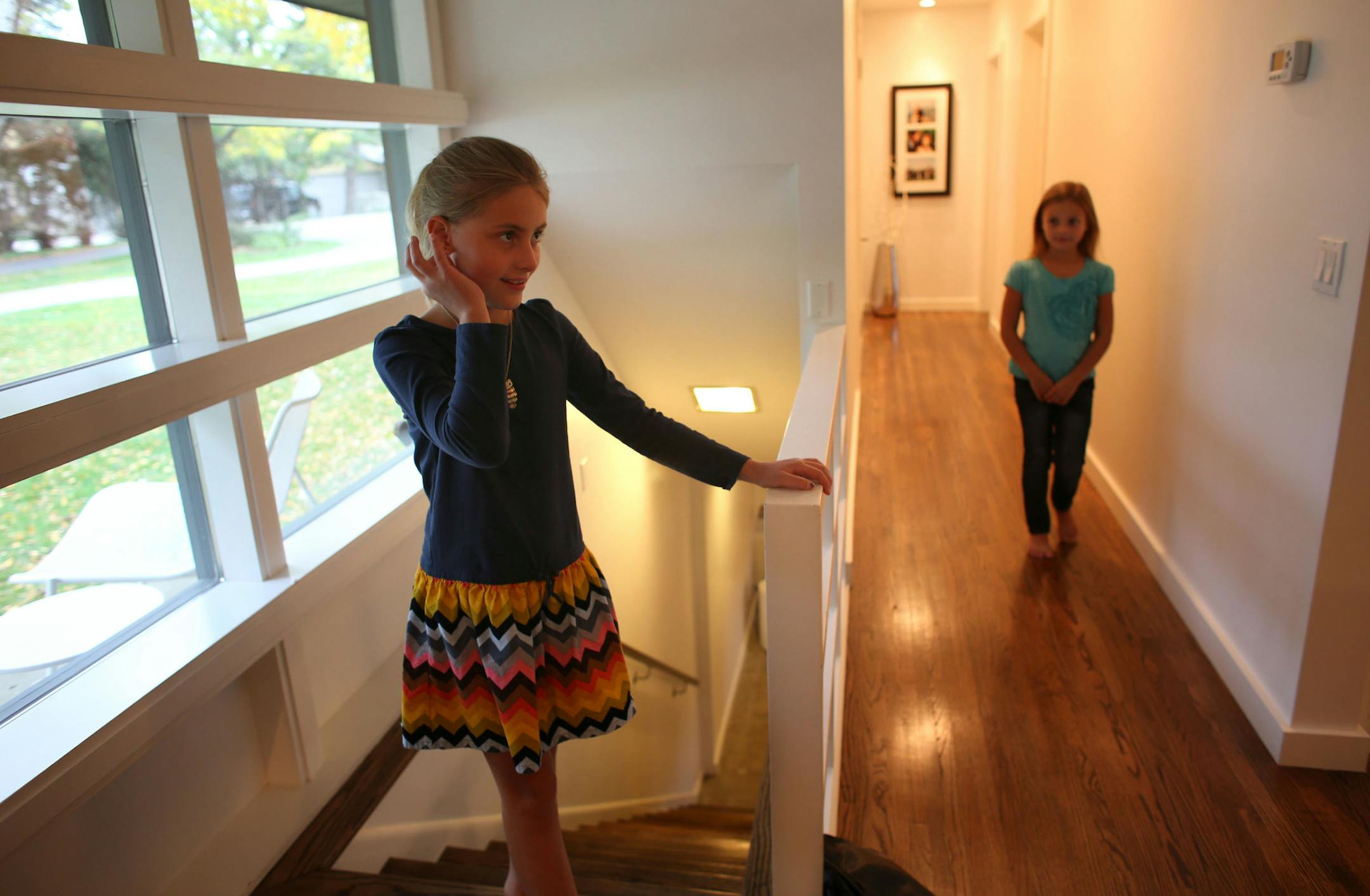 Joely Emerson, 8, left and her sister Lila, 7, walked toward the lving room after their parents called them in their home in Edina, Min., Thursday, October 17, 2013. ] (KYNDELL HARKNESS/STAR TRIBUNE) kyndell.harkness@startribune.com