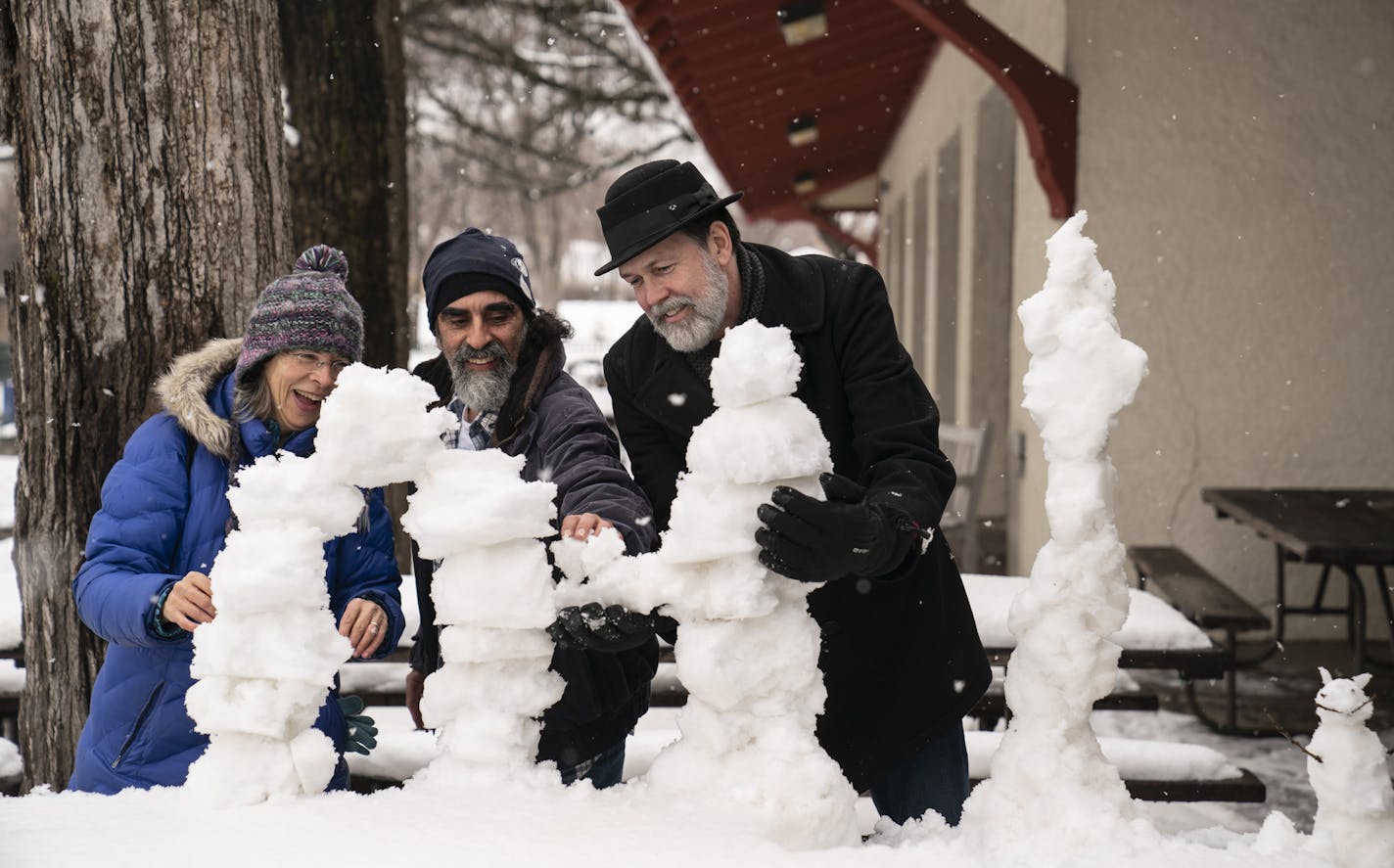 From the left; Chris Kunz, Hassan Saffouri and Dean Muldoon decided to make snow sculptures on the picnic tables outside Sea Salt Eatery after having their annual first meal at the restaurant on opening day in Minneapolis, Minn., on Friday, April 12, 2019. Although due to this year's opening day weather they did not eat at the picnic tables, but inside the restaurant. ] RENEE JONES SCHNEIDER &#x2022; renee.jones@startribune.com