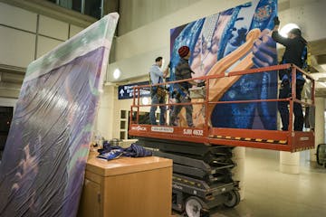 Workers got ready to affix one of six panels to a wall at the Tram level of Minneapolis-St. Paul International Airport's (MSP) Terminal 1. The work, e