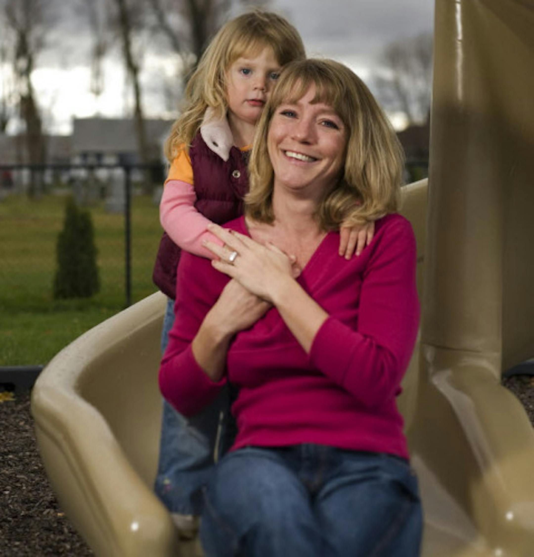 Liz Rickert and 2-year-old daughter Annika, were at this playground in Miesville, where Rickert lost her wedding ring Oct. 19. After a frantic search, a call from an Orono woman whose own daughter had found it led to its return. The ring in question is glinting from Rickert's left hand.