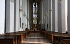 A man sits in the empty 'Church of our Lady' in Munich, Germany, Thursday, March 19, 2020. The church cancelled all worship services but is open only 