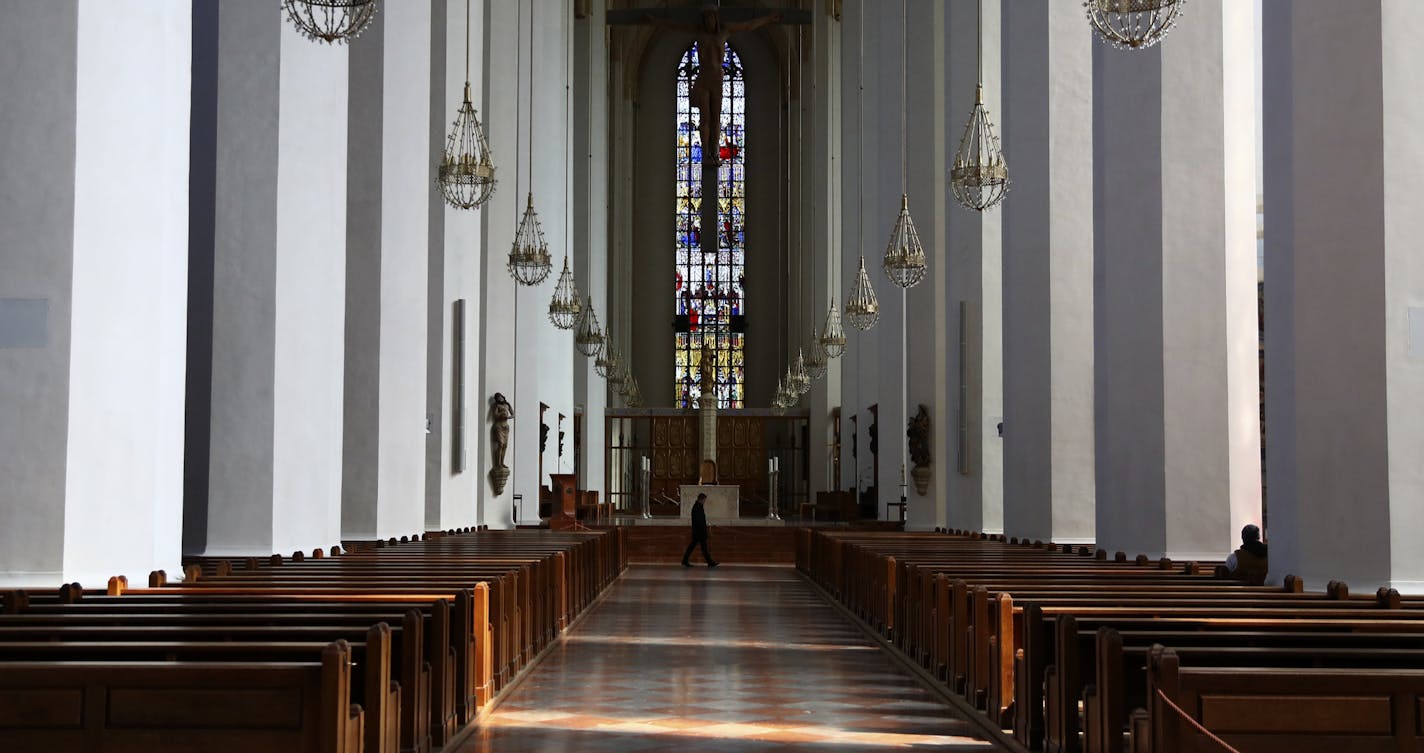 A man sits in the empty 'Church of our Lady' in Munich, Germany, Thursday, March 19, 2020. The church cancelled all worship services but is open only for single prayers. For some, especially older adults and people with existing health problems, it can cause more severe illness, including pneumonia. (AP Photo/Matthias Schrader)