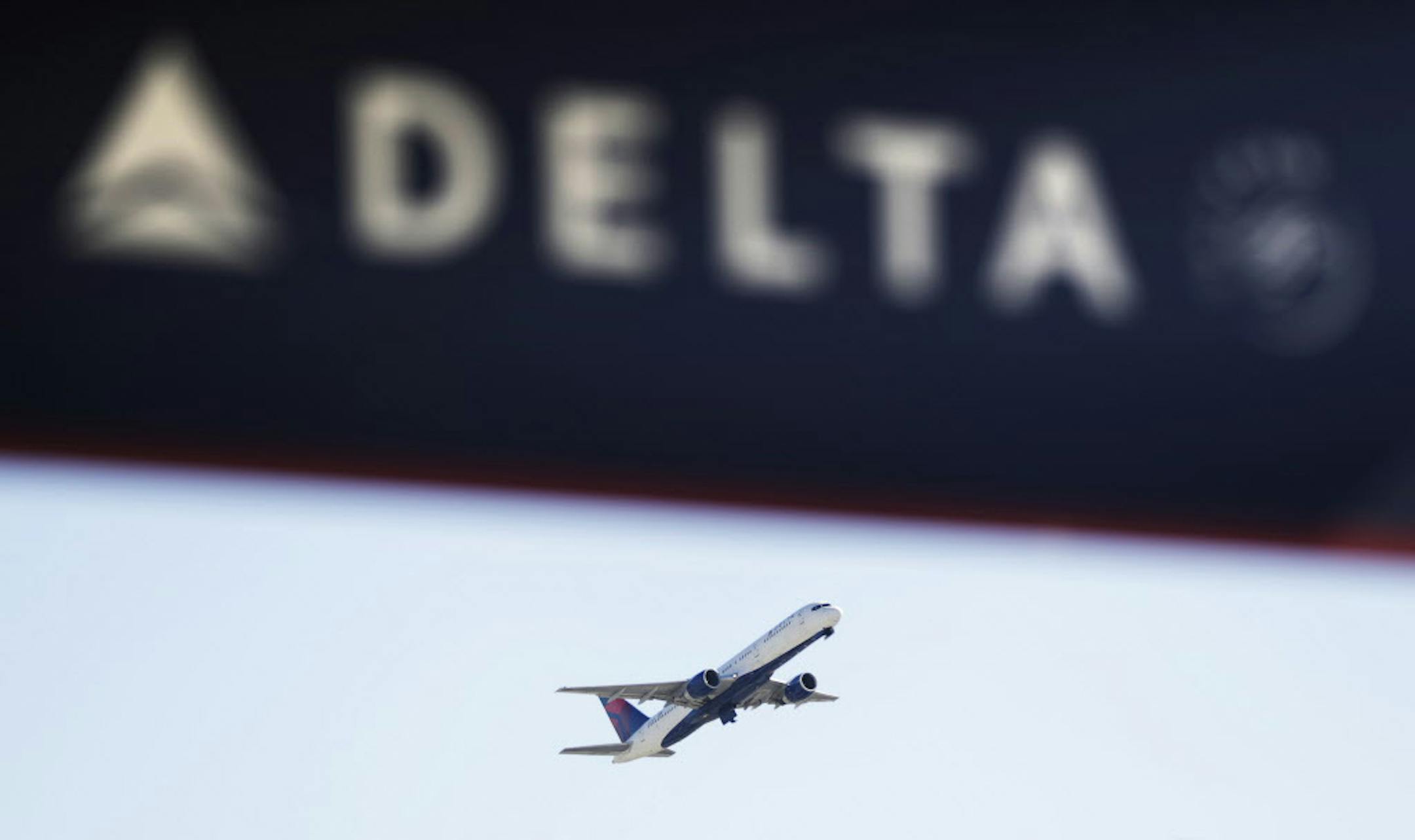 A Delta Air Lines flight takes off from Hartsfield-Jackson Atlanta International Airport in Atlanta, Monday, Jan. 30, 2017. Delta Air Lines, recovering from a weekend technology outage, canceled more flights Monday but said that the issue has been resolved. (AP Photo/David Goldman)