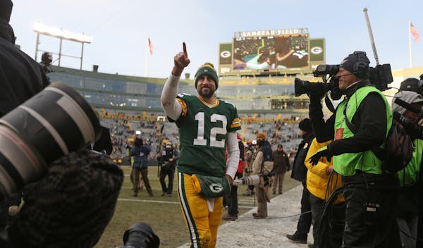 Green Bay Packers quarterback Aaron Rodgers waves to the fans as he left Lambeau Field after a game last season.