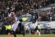 Philadelphia Eagles' Nick Foles passes during the first half of an NFL divisional playoff football game against the Atlanta Falcons, Saturday, Jan. 13