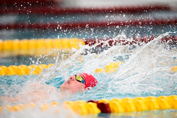 Eden Prairie senior Luke Logue swims the back stroke in a heat of the 200 IM during the preliminaries of the Class 2A boys swimming state meet Friday,