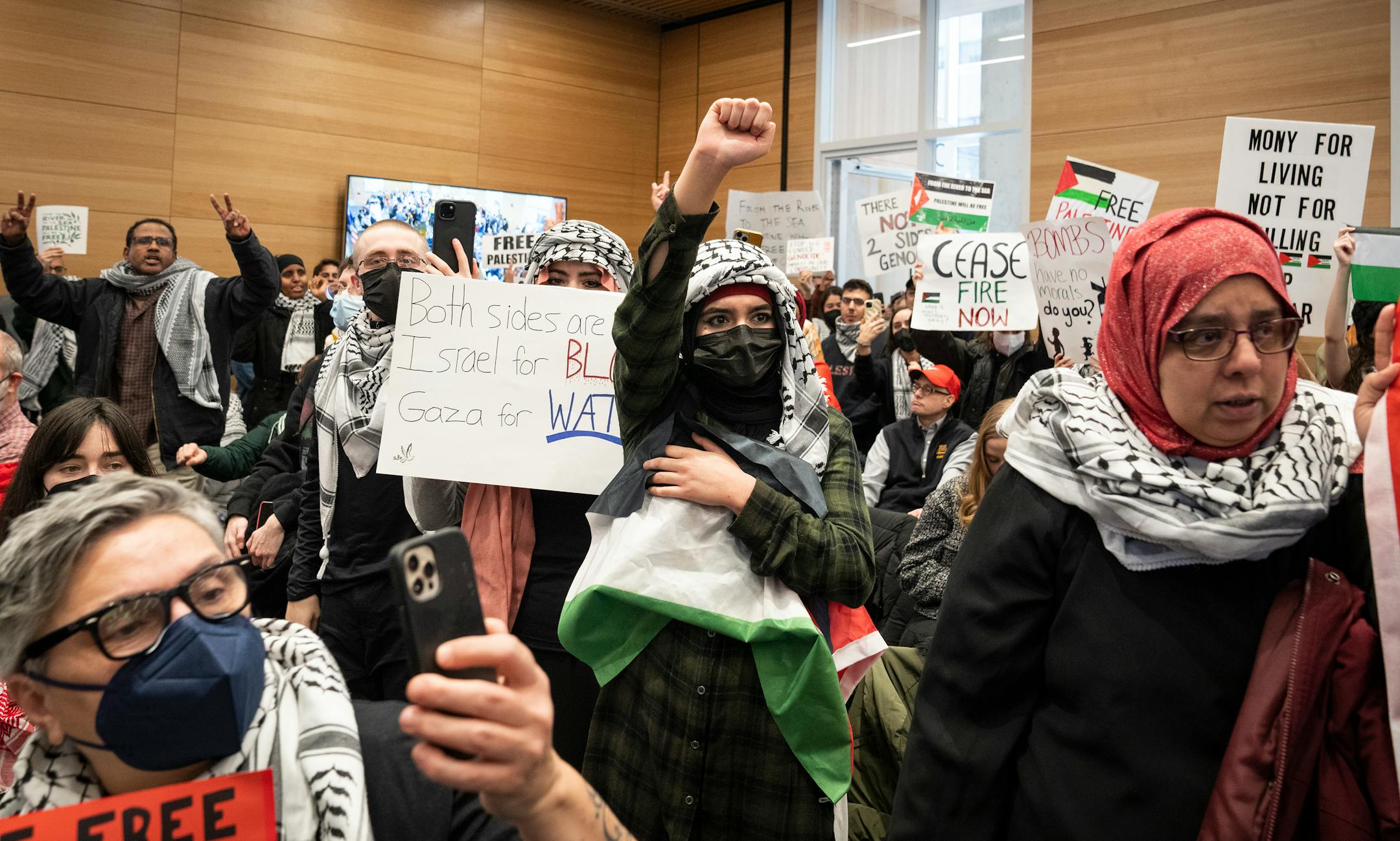 Supporters of a resolution calling for a cease-fire in Gaza stand during Minneapolis City Council's first meeting of 2024 in Minneapolis, Minn. Monday, Jan. 8, 2024. ] LEILA NAVIDI • leila.navidi@startribune.com