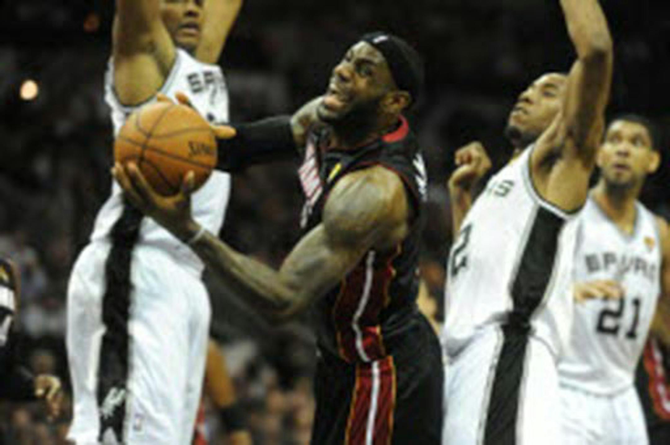 The Heat's LeBron James grimaced as he fell to the floor while driving against the San Antonio Spurs during Game 2 of the NBA Finals on Sunday.