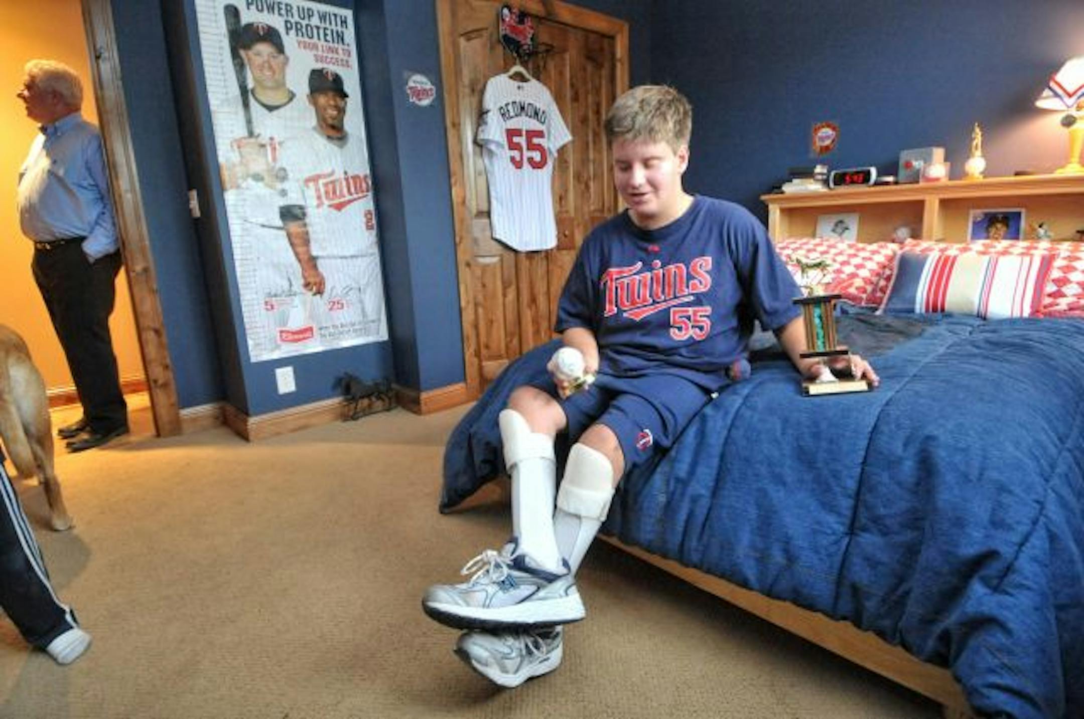 Josh Altman, 12, showed off his autographed Twins baseball and horseback-riding trophy. His dad, Larry Altman, left, has become an expert on financial planning for special-needs families. Josh has spina bifida. Altman recommends that families of special-needs children invest in cash-value life insurance and disability insurance.