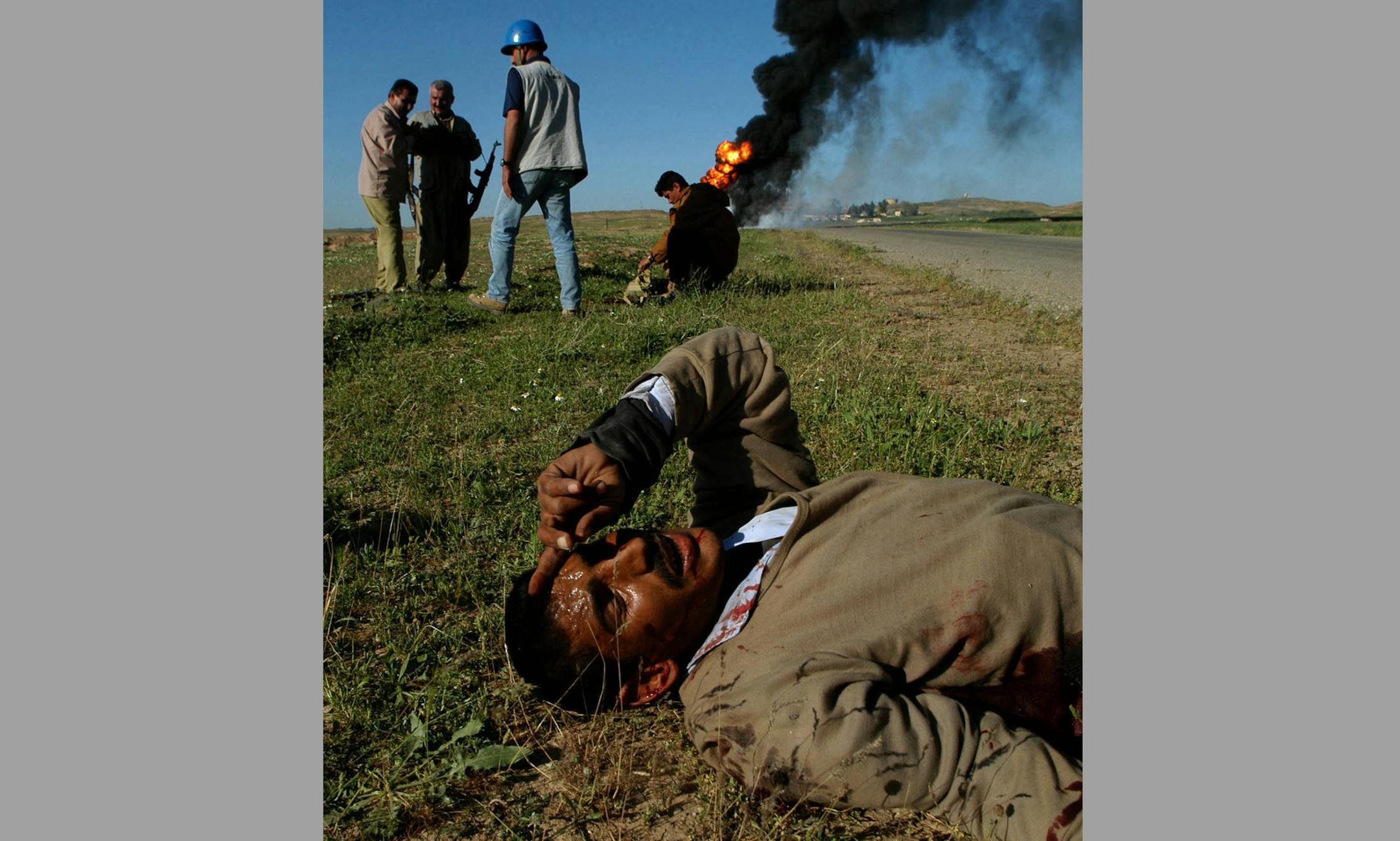 Kirkuk, Iraq - April 10, 2003 - Saddam&#xcc;s Fedayeen fighter was shot and left to die by local Kirkuk militia. He pleads for his life with American journalists while Kurds ignore him completely. MAGAZINES, BROADCAST, ST. PAUL OUT ORG XMIT: MIN2016012212520260