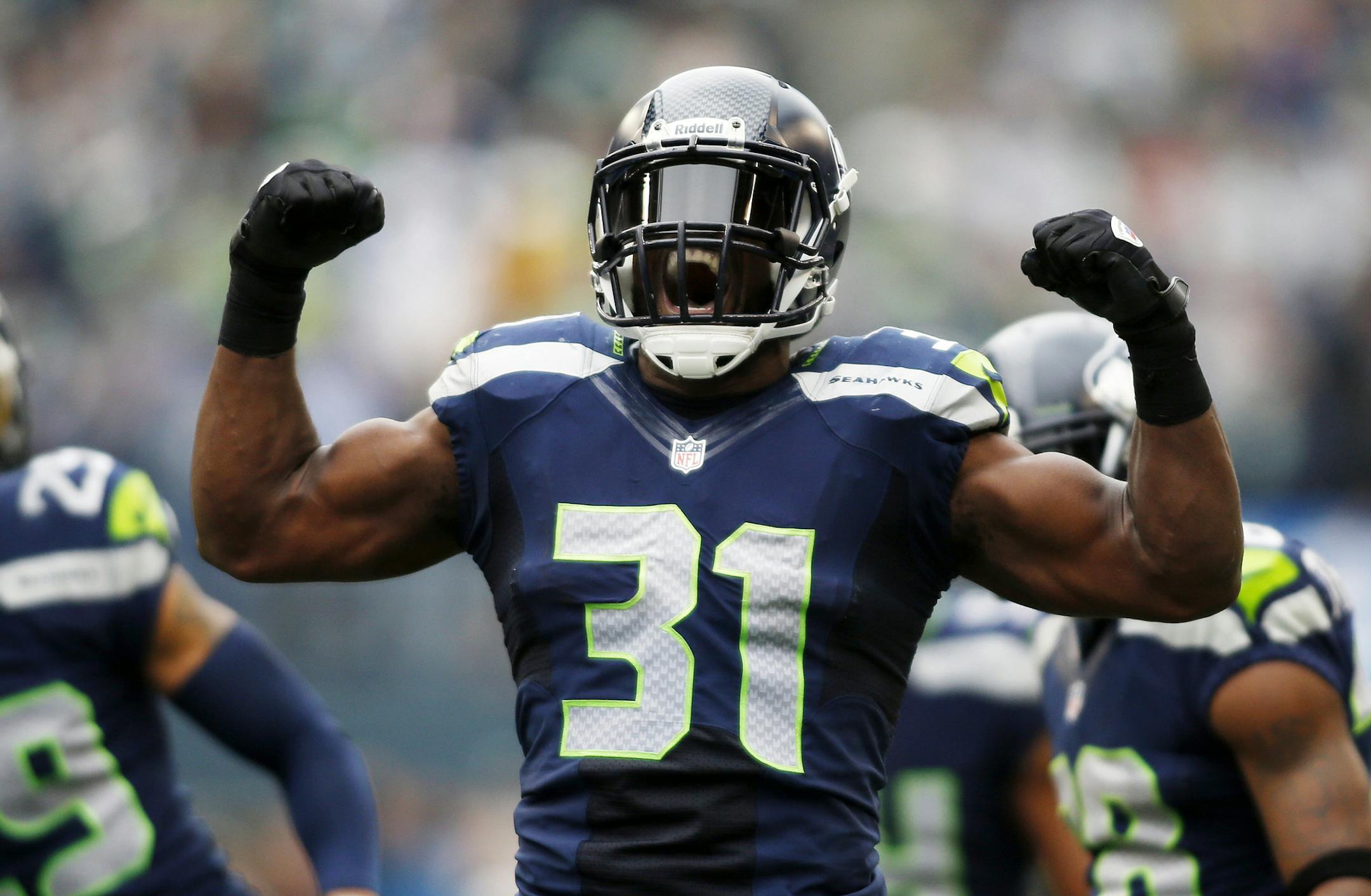Seattle Seahawks strong safety Kam Chancellor (31) celebrates a hit on St. Louis Rams' Stedman Bailey in the first half of an NFL football game, Sunday, Dec. 29, 2013, in Seattle. (AP Photo/John Froschauer) ORG XMIT: SEA119