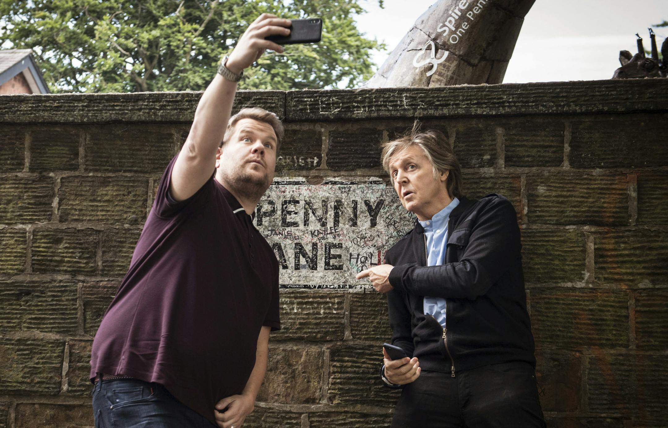 In this image released by CBS, Paul McCartney, right, joins host James Corden as they take a selfie on Penny Lane during the "Carpool Karaoke" segment on "The Late Late Show with James Corden." (Craig Sugden/CBS via AP)