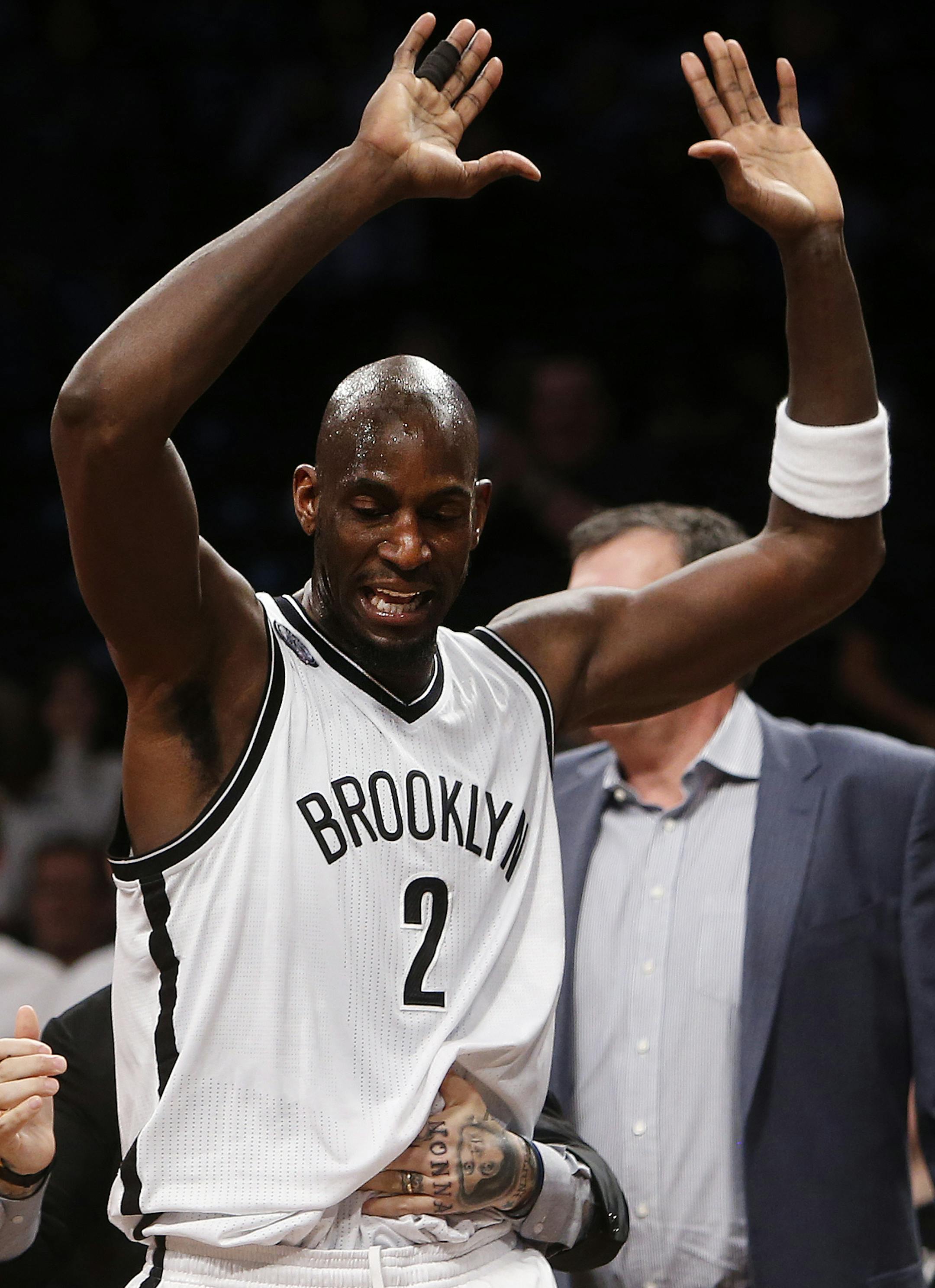 Brooklyn Nets' Kevin Garnett is restrained after an altercation with Houston Rockets' Dwight Howard during the first quarter of an NBA basketball game Monday, Jan. 12, 2015, in New York. Garnett was ejected from the game as a result of the incident. (AP Photo/Jason DeCrow)