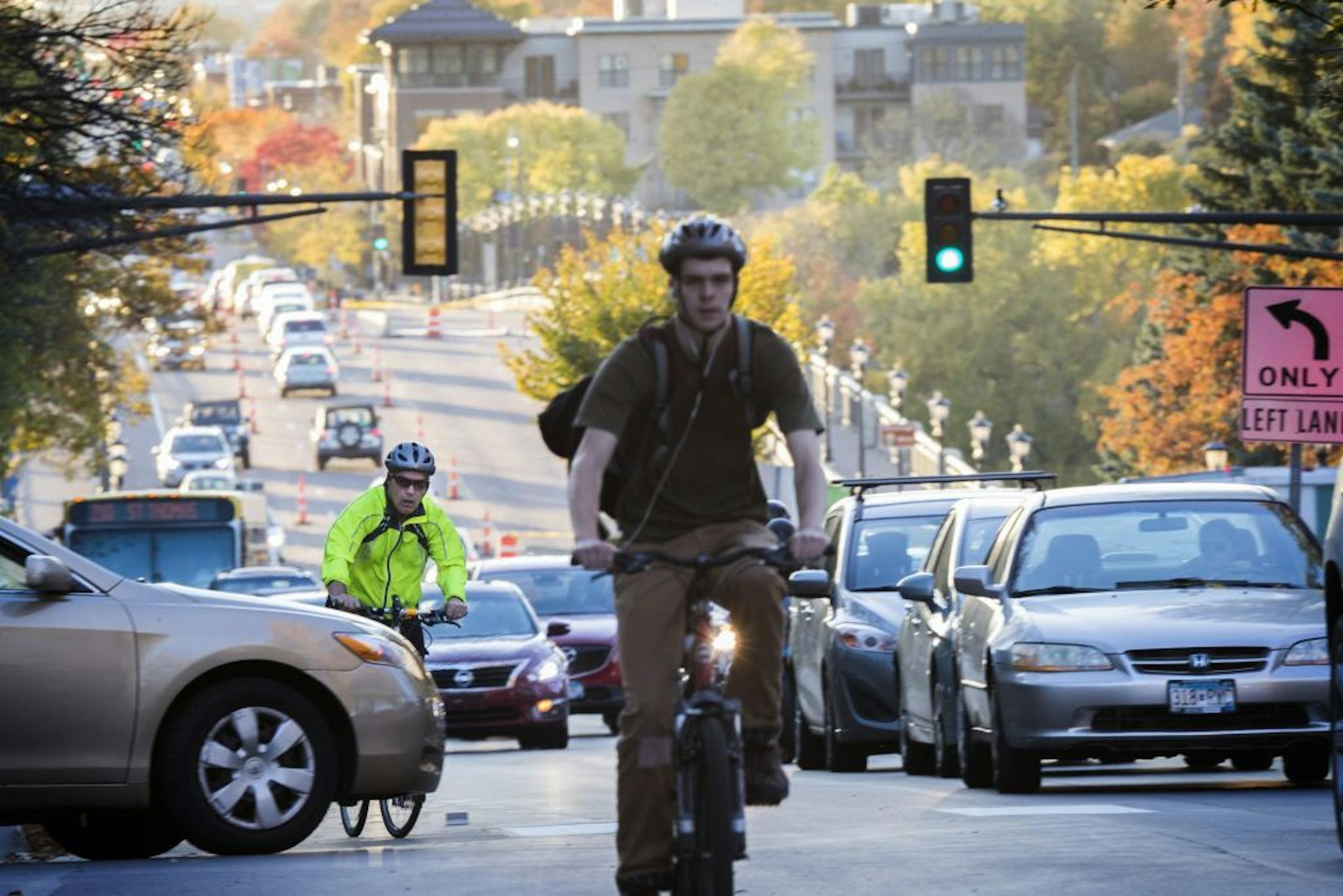 Cyclists and traffic move up Marshall Avenue eastbound in St. Paul during rush hour.
