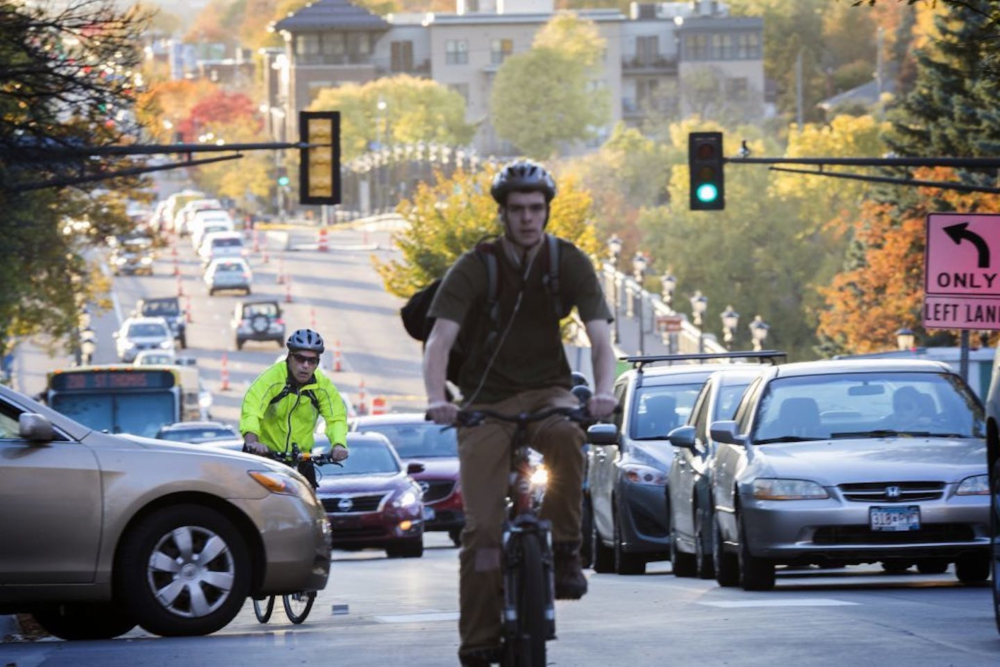 Cyclists and traffic move up Marshall Avenue eastbound in St. Paul during rush hour.