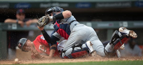 Cleveland Indians catcher Kevin Plawecki (27) tagged out Twins pinch runner Ehire Adrianza (13) as he tried to score on a double by Marwin Gonzalez in