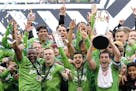 Sounders captain Nicolas Lodeiro, right, lifted up the MLS Cup as he celebrated with teammates after Seattle defeated Toronto FC for last year's champ