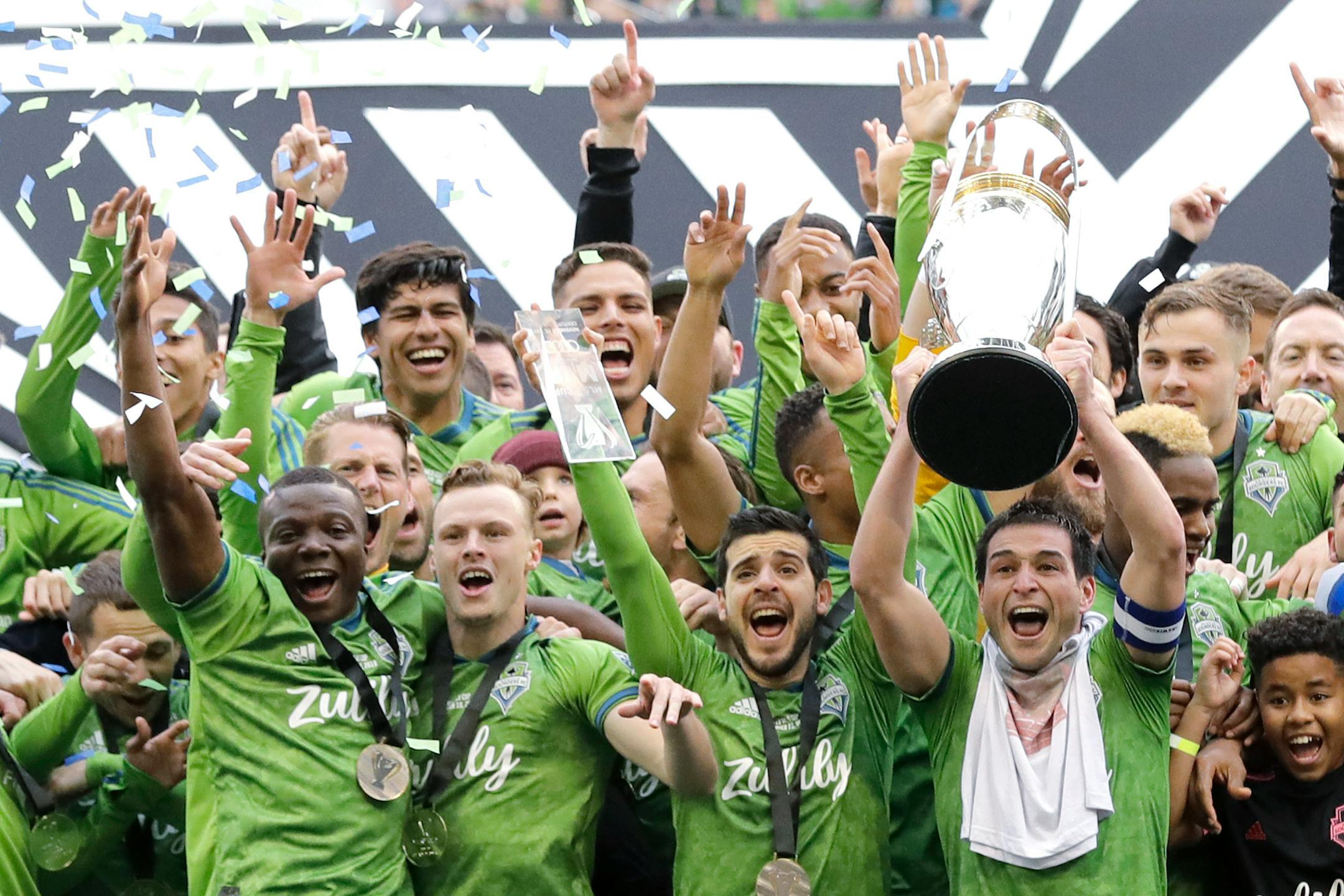 Sounders captain Nicolas Lodeiro, right, lifted up the MLS Cup as he celebrated with teammates after Seattle defeated Toronto FC for last year's championship.