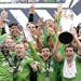 Sounders captain Nicolas Lodeiro, right, lifted up the MLS Cup as he celebrated with teammates after Seattle defeated Toronto FC for last year's champ