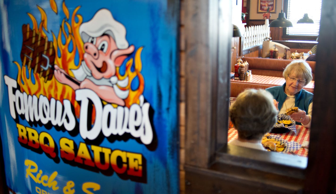 Customer Neta Moon, right, eats with a friend at a Famous Dave's of America Inc. franchise restaurant in Peoria, Illinois, U.S., on Thursday, March 21, 2013. Famous Dave's of America is a chain of barbecue restaurants started in 1994 that has 191 locations in 34 U.S. states and one Canadian province. Photographer: Daniel Acker/Bloomberg *** Local Caption *** Neta Moon