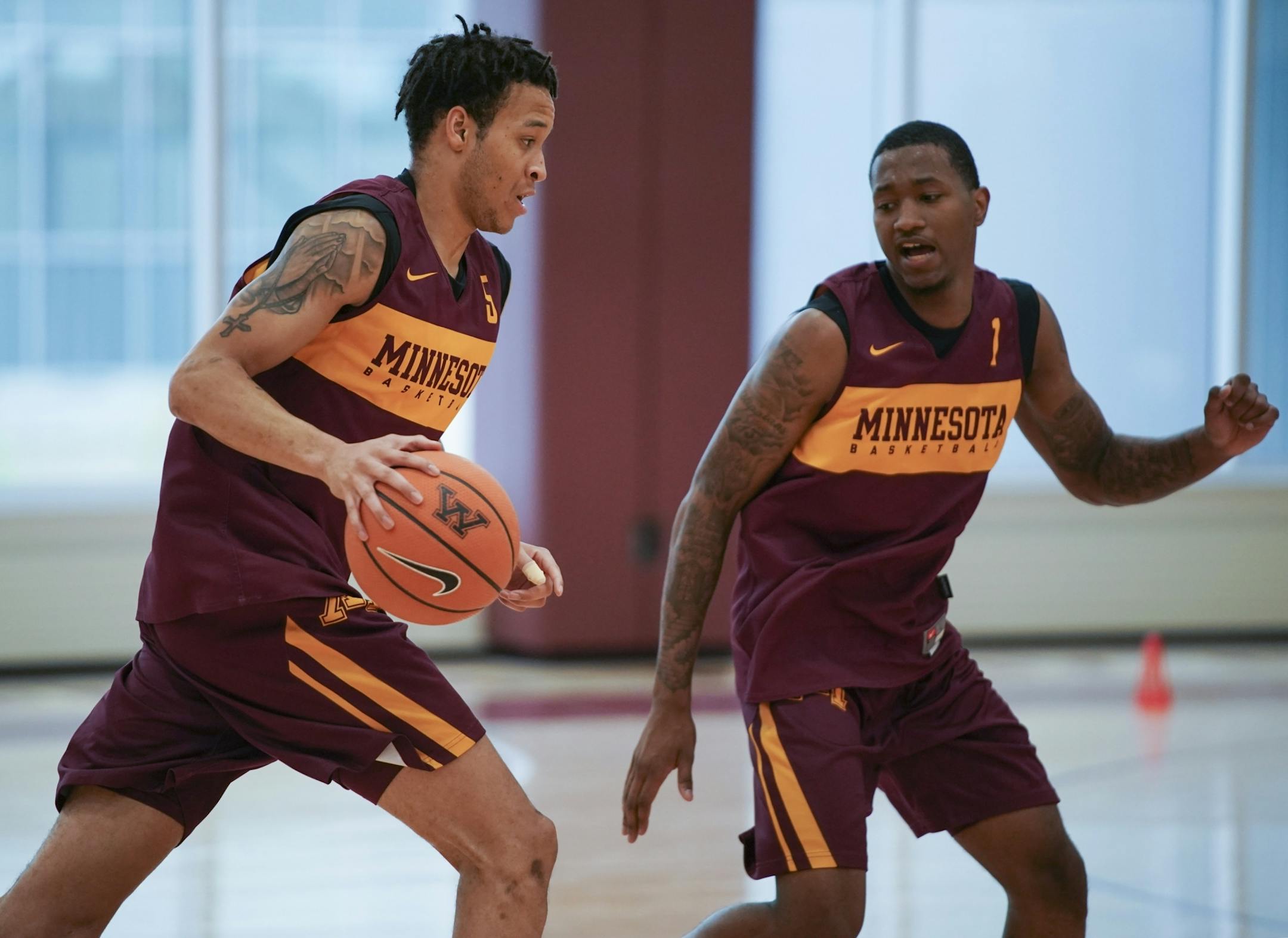 Guards Amir Coffey, left, and Dupree McBrayer, both coming off injuries from last season, took part in a drill during practice Tuesday afternoon.