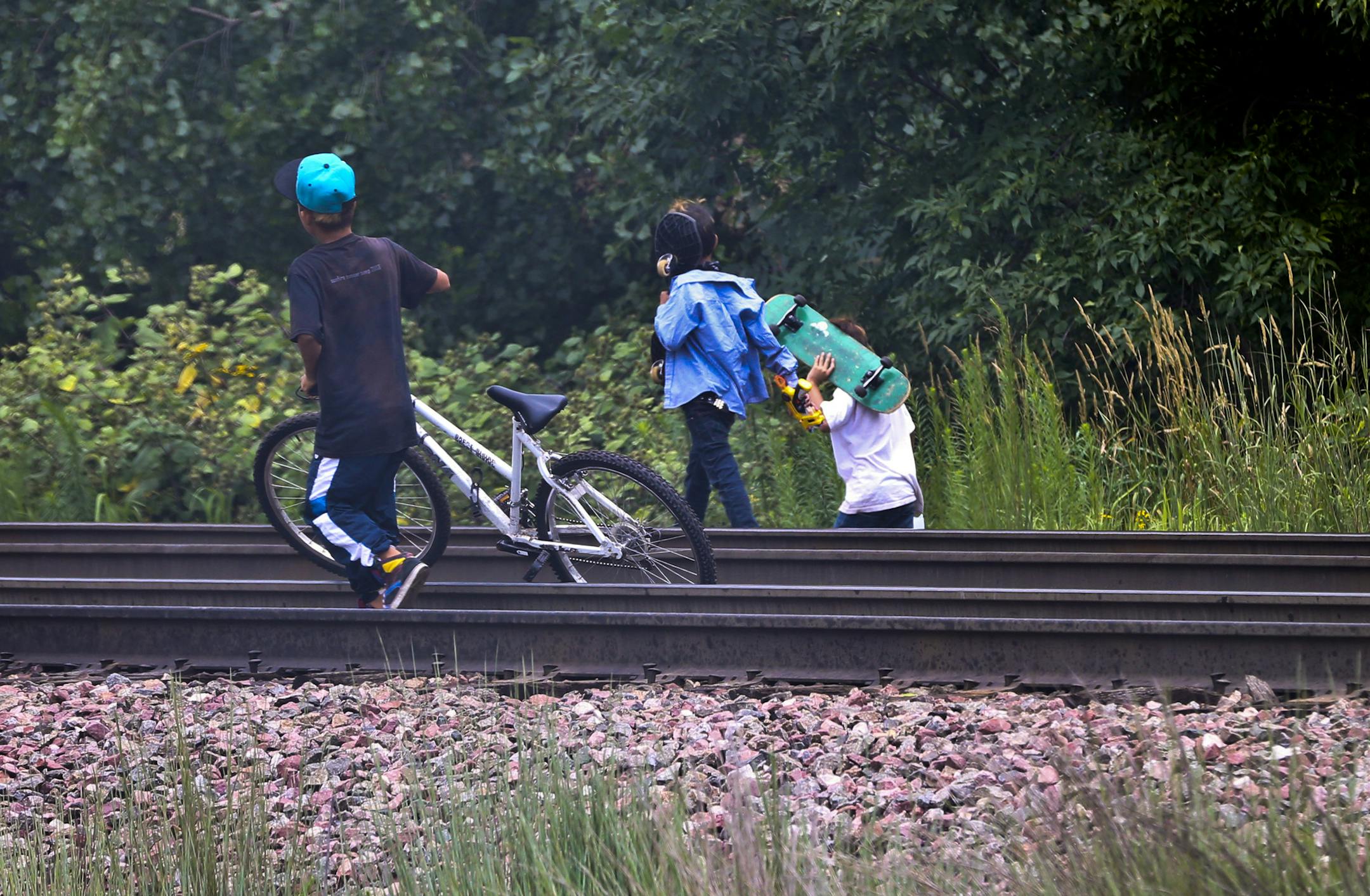 A group of boys walked along the on the tracks a couple hundred yards away from where a 9-year-old severed his feet while playing on a train going through the neighborhood Last night, photographed in St. Paul, Minn. on Friday, August 16, 2013. ] (RENEE JONES SCHNEIDER • reneejones@startribune.com) **I yelled and told them it was dangerous and to get off the tracks, I'm sure I'll get a bunch of hatemail ***