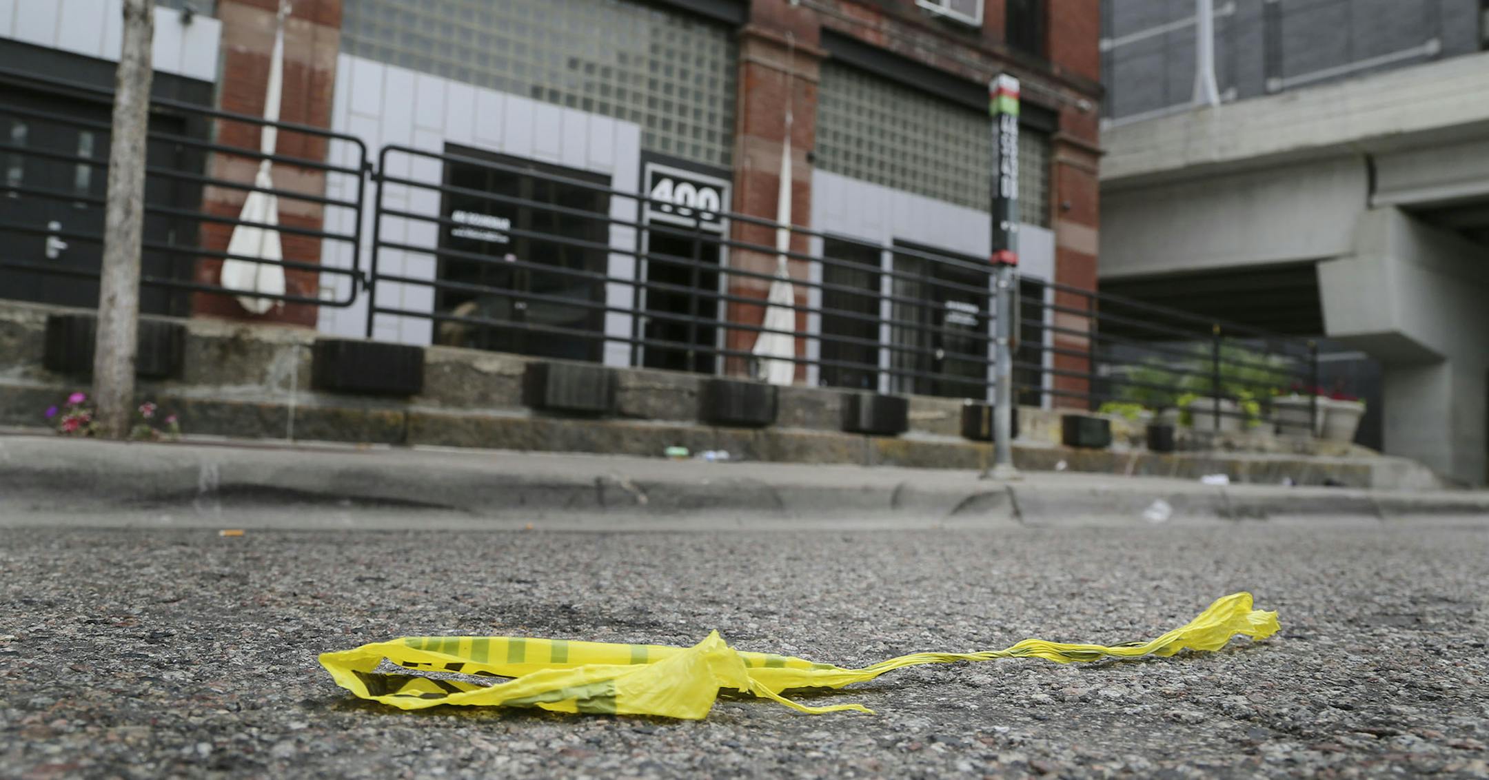 Several people were shot by a gunman early Saturday morning at Soundbar in Minneapolis Saturday, Aug. 9, 2014. Here, police tape is discarded in the street, several hours after the shooting.