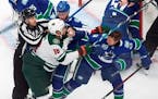 The Wild's Jordan Greenway and Vancouver's Jay Beagle mixed it up during a first-period skirmish in Game 1 Sunday night.